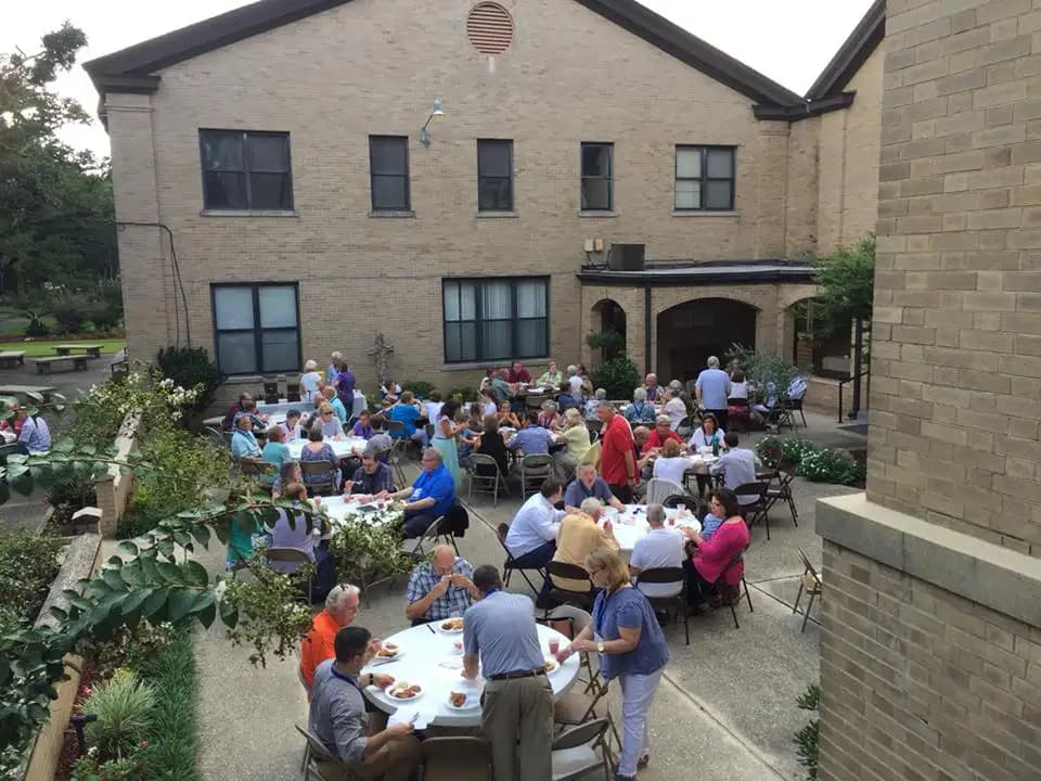The church family sharing a meal in the McIlwain courtyard